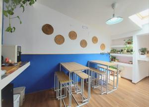 a kitchen with blue walls and tables and stools at Casa sulla Punta in Marina di Camerota