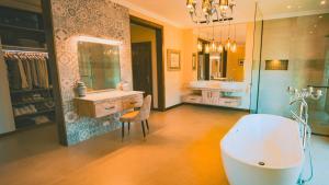 a large bathroom with a tub and a sink at Chamarel Mountain chalets in Chamarel