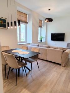 a living room with a table and a couch at Vytenio22- 2 bedrooms in Prienai