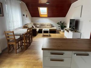 a living room with a couch and a table at Rooms Apartma Cerknica in Cerknica