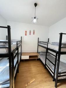 a room with three bunk beds and a light at FanHostel European Championship 24 Cologne City Center in Cologne