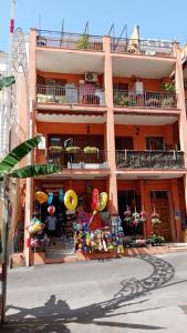 an apartment building with a market in front of it at Casa sulla Punta in Marina di Camerota