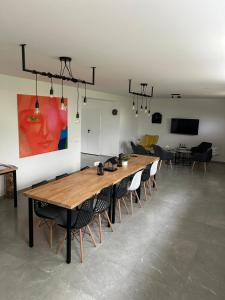 a conference room with a large wooden table and chairs at Penzion NoFasada in Bzenec