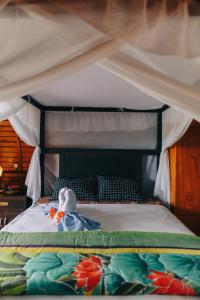 a stuffed animal sitting on top of a bed at Villa Rumah Kayu Lovina in Lovina