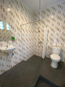 a bathroom with a toilet and a sink at Hotel Bima Majalengka in Majalengka