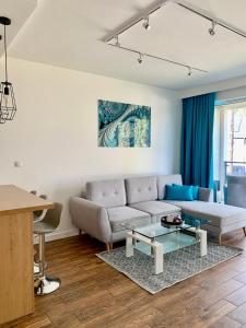 a living room with a couch and a table at REMAR - Apartamenty nad Jeziorem Necko in Augustów