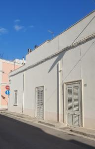 a white building on the side of a street at Dimora salenTina in Tricase +5 photos