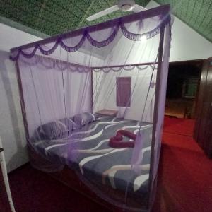 a bed with a canopy in a room at Bamboo Bay in Arugam Bay