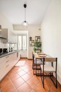 a kitchen with a table and chairs in a room at Country House nella Winery in Frascati