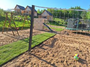 a playground with a soccer ball in the dirt at Domek Na Mazurach in Bogaczewo