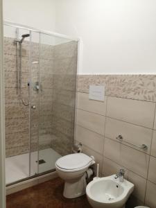 a bathroom with a shower and a toilet and a sink at B&B Le Coccole di Galluzzo Gabriele in Aragona +20 photos