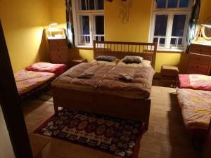 a bedroom with two twin beds and a rug at Country house Horné Držkovce in Horné Držkovce