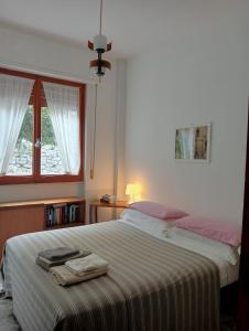 a bedroom with a bed and a window at Home Caviglia CITRA 09029-LT-0618 in Finale Ligure