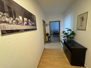a hallway with a painting on the wall and a plant at Monteur Home in Solingen