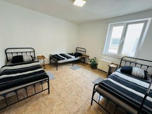 a room with three beds and a window at Monteur Home in Solingen