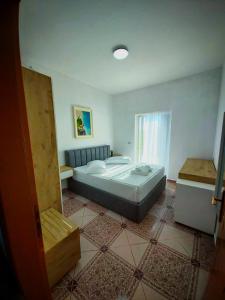 a bedroom with a large bed and a window at Residence Vera in Ksamil