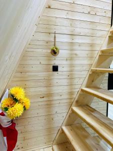 eine Holztreppe mit gelben Blumen in einem Zimmer in der Unterkunft Phaliani's Heaven in Mestia