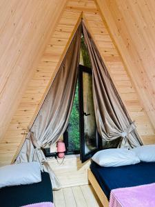 a room with two beds and a window at Phaliani's Heaven in Mestia