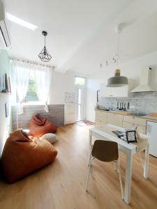 a room with a kitchen with a table and a pillow on the floor at Harmony apartments in Portorož