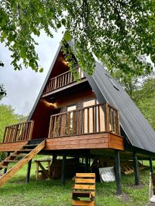 a large house with a gambrel roof with a deck at Phaliani's Heaven in Mestia