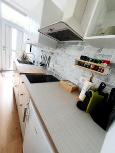 a kitchen with white cabinets and a counter top at Harmony apartments in Portorož