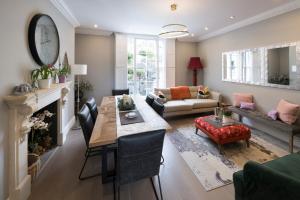 a living room with a table and a couch at The Old Wine Merchant's House in Bath