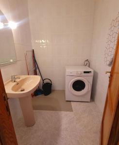 a bathroom with a washing machine and a sink at Casa Pancho Lanzarote in Playa Honda +3 photos