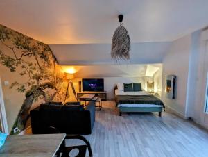 a living room with a bed and a couch at L'envol in Achicourt