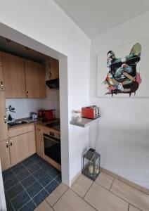 a kitchen with white walls and a counter and a stove at Bremen City in Bremen