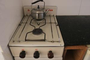 a stove with a pot on top of it at Playa Grande Dos Ambientes in Mar del Plata