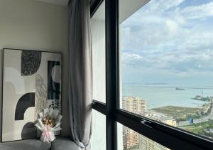 a room with a window with a view of the ocean at DD Condominium 2Bedroom Sea view Georgetown Penang in Jelutong