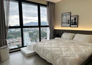 a bedroom with a white bed and large windows at DD Condominium 2Bedroom Sea view Georgetown Penang in Jelutong