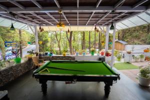 a pool table in the middle of a patio at Rooms at Little Heaven in Rājpur