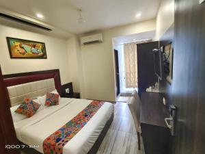 a hotel room with a bed and a window at New Axis International By Glitz Hotels in Mumbai