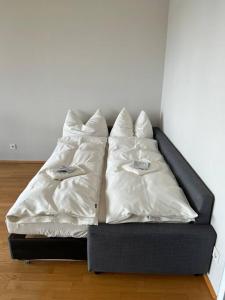 a bed with two pillows on it in a room at Kaiserstrand Apartment Bodensee - Lake Constance, Lochau - Bregenz, Austria in Lochau
