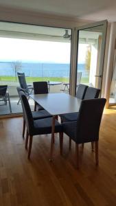 a table and chairs in a room with a view at Kaiserstrand Apartment Bodensee - Lake Constance, Lochau - Bregenz, Austria in Lochau