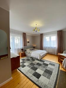 a large bedroom with a bed and a rug at Gospodarstwo Agroturystyczne JAGODA in Błonie
