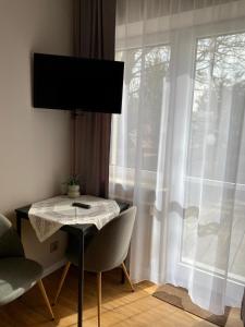 a room with a table and chairs and a window at Agroturystyka JAGODA in Błonie