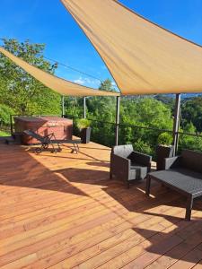 a tent on a deck with chairs and a grill at Emas House in Gornja Stubica +16 photos