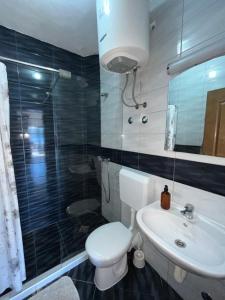 a bathroom with a toilet and a sink and a shower at Villa Bellevue in Neum +26 photos