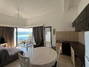 a living room with a table and a kitchen with a view at Villa Bellevue in Neum