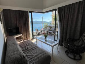 a living room with a couch and a view of the ocean at Villa Bellevue in Neum