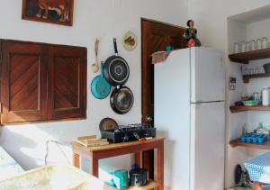 a kitchen with a white refrigerator and wooden cabinets at Casa Azul in San Agustinillo