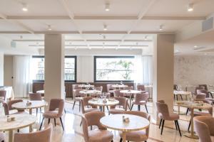 a dining room with tables and chairs at Villa Nicolli Romantic Spa Resort - Adults Only in Riva del Garda