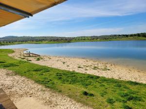a view of a lake with a picnic table at Casa da Chaminé - A Casa da Chaminé "torta" in Amieira