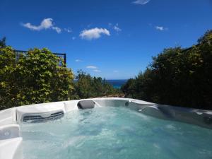 a jacuzzi tub with the ocean in the background at Résidence Belvedere de Palombaggia in Porto-Vecchio