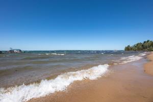 a view of the ocean from the beach at Cozy Beach Front Condo AC Beach Waterfront in Traverse City