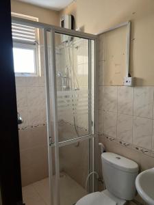 a bathroom with a shower and a toilet and a sink at Kalan Digana (Kandy) in Digana