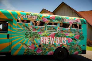 a colorful bus with people looking out the window at Cozy Beach Front Condo AC Beach Waterfront in Traverse City
