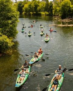 a group of people in kayaks on a river at Cozy Beach Front Condo AC Beach Waterfront in Traverse City +44 photos